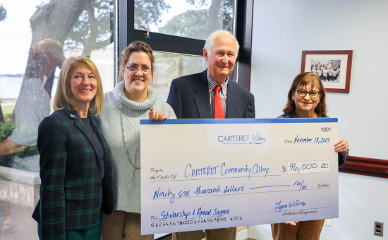 Lynn Eure Presents Check for Scholarships