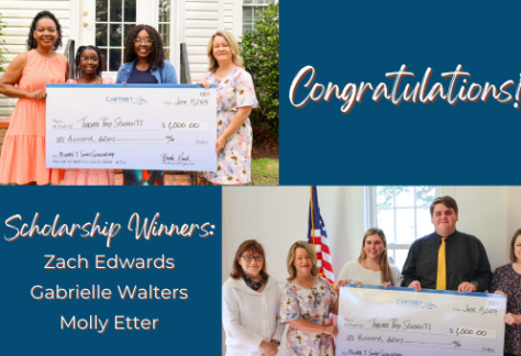 Picture of students who are being awarded scholarships holding a big check