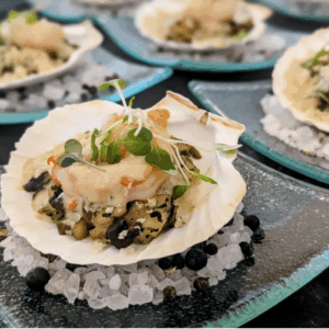 oysters on a shell sitting on rock salt