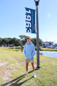 A student on campus by the flag pole.