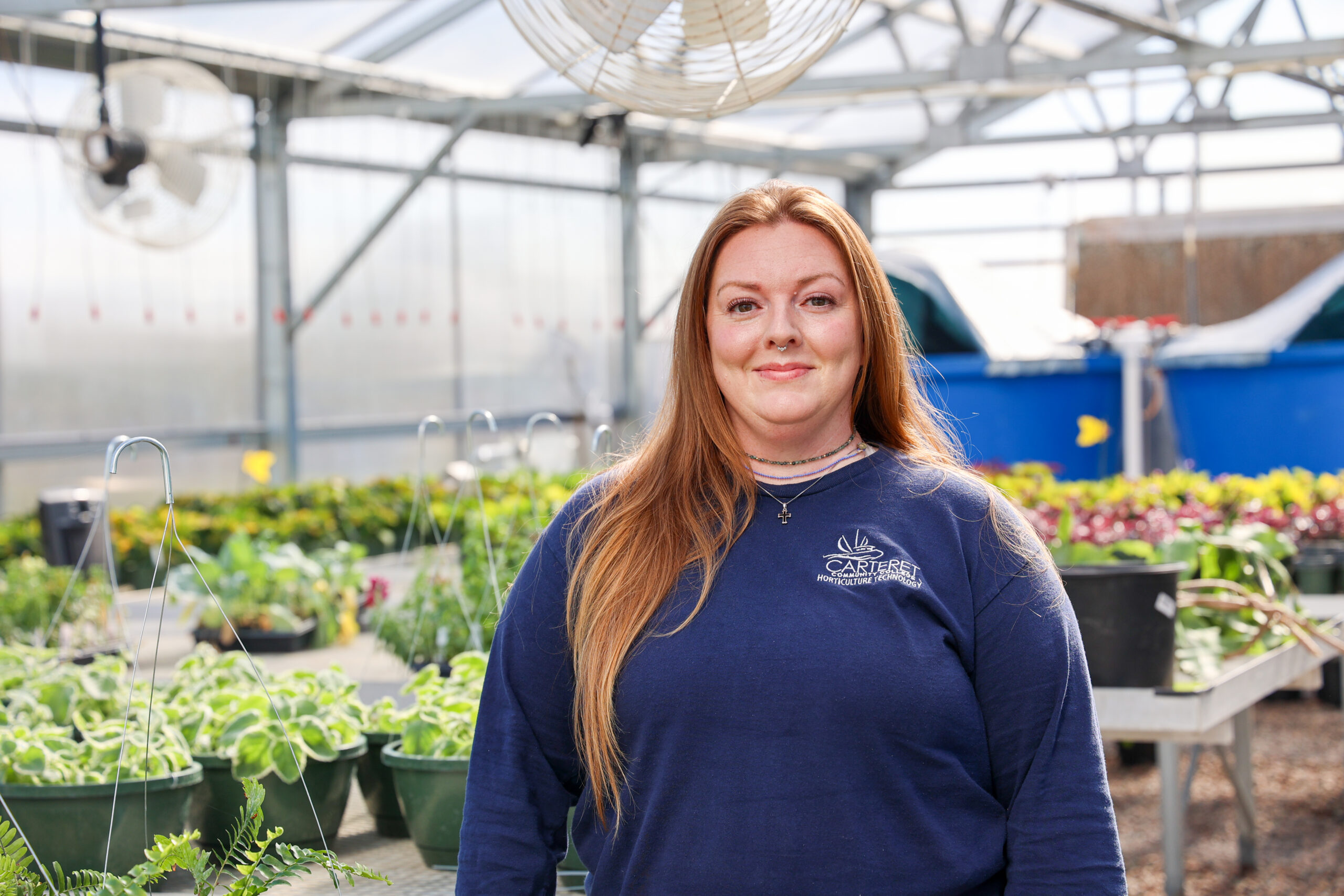 a female student in the greenhouse