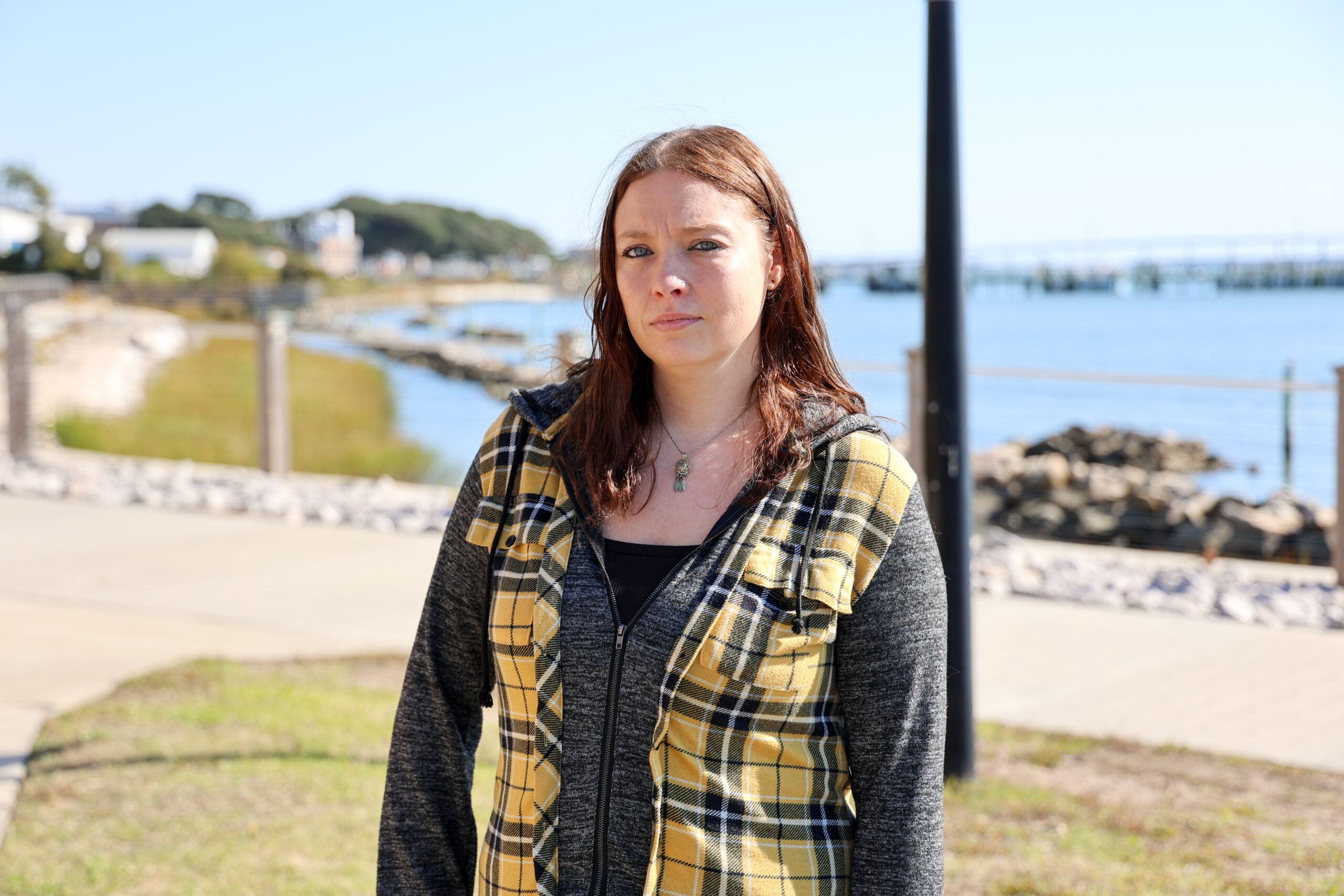 A student standing on the waterfront at the college