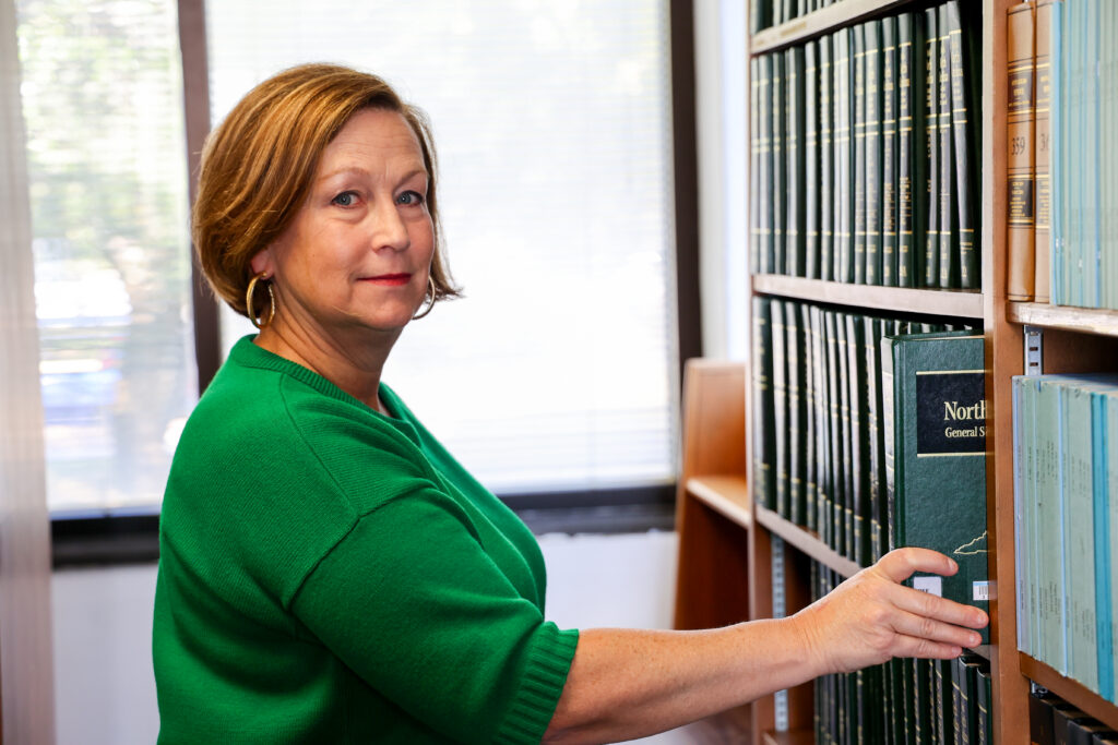 A female student in the library holding a book