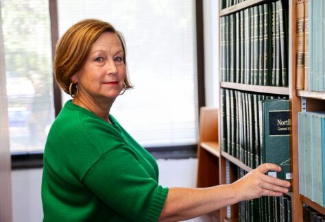 A female student in the library holding a book