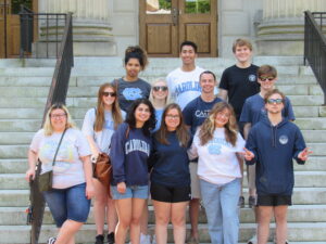 a group of students wearing unc shirts on the steps outside