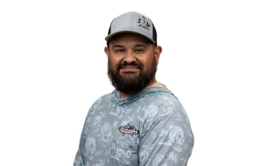 A male student in a grey shirt and grey hat