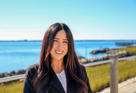 Female outside by the sound.