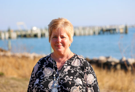 a picture of a women outside by the water