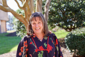 A picture of a female standing outside.