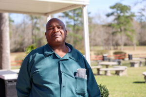 An incarcerated student stands outdoors at Carteret Correctional Center, reflecting the impact of education and reentry programs on personal growth.