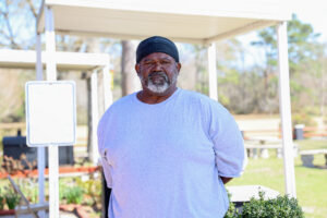 An incarcerated student stands outside at Carteret Correctional Center, representing participants in workforce and reentry preparation programs.