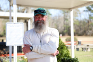 A program participant stands outdoors at Carteret Correctional Center, illustrating the human impact of education and second-chance opportunities.