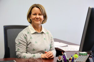 a women sitting in front of a desk