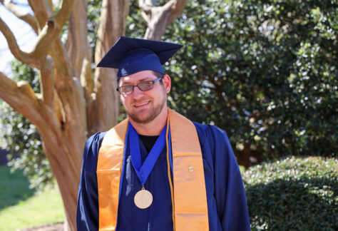 student in graduation cap, gown, and stole