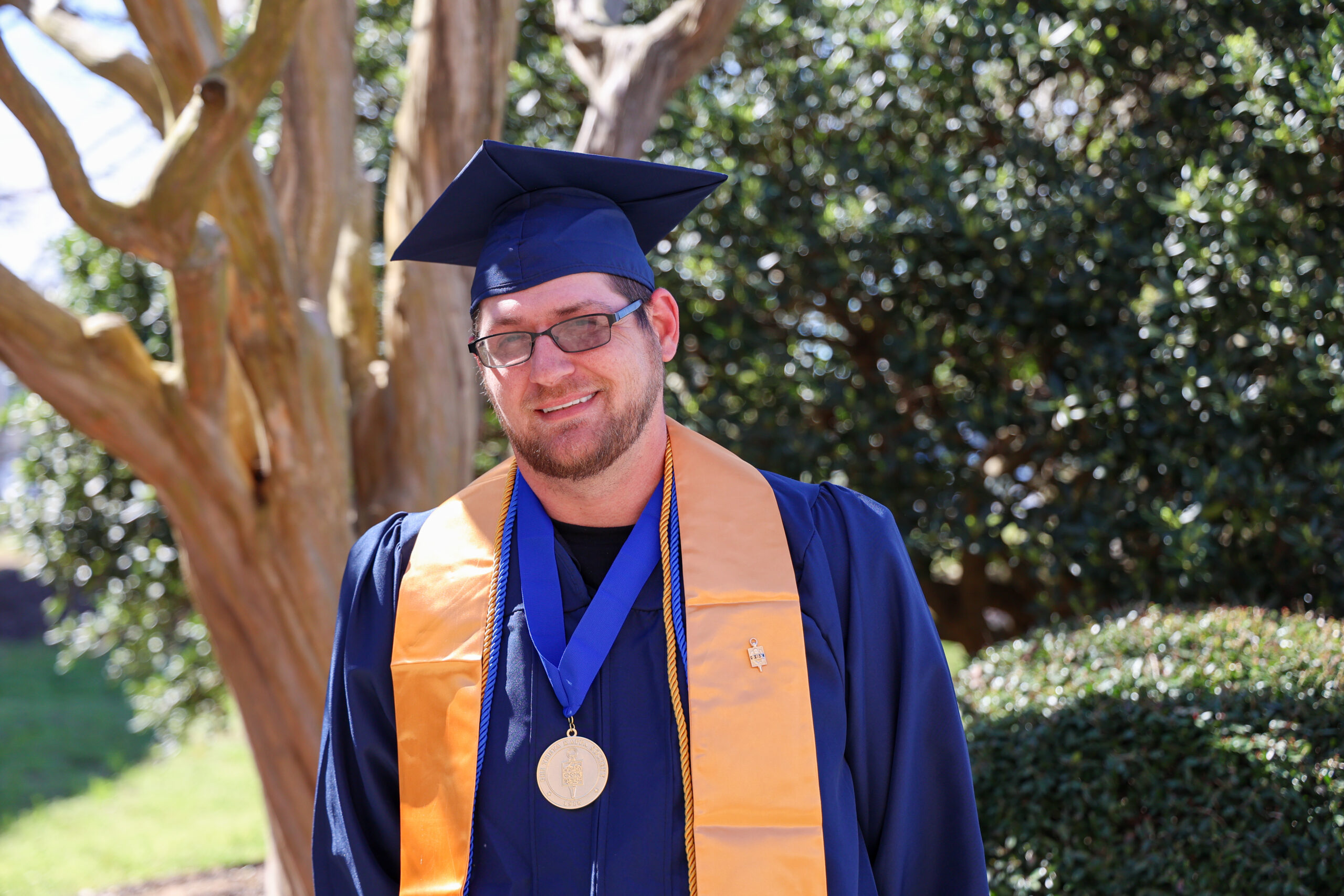 student in graduation cap, gown, and stole