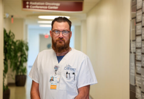 Male student standing in the hospital in his scrubs